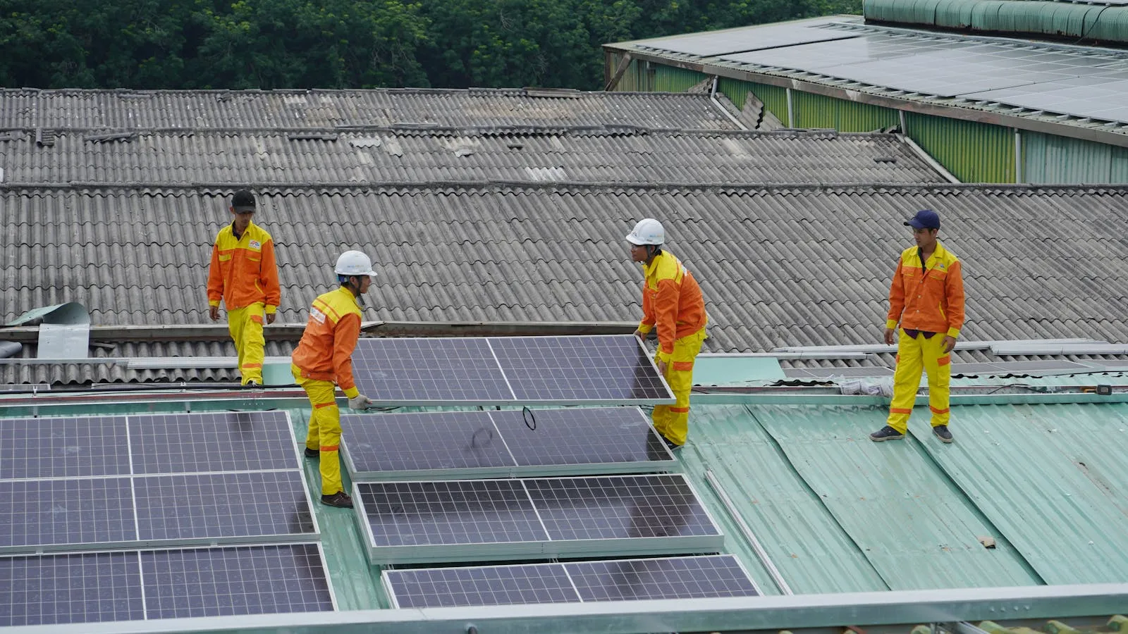 Solar installation crew placing panels on a roof