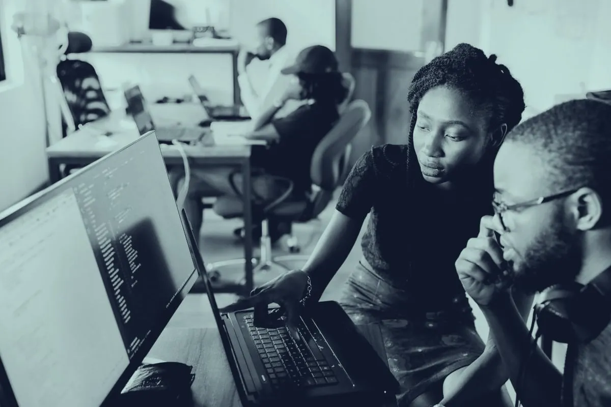 Software development team collaborating at their workstations
